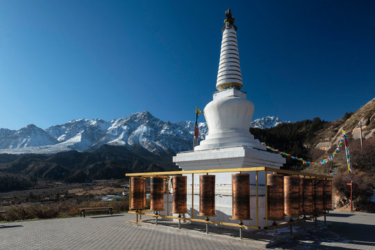 White Buddhist Stupa and Tibetan prayer wheels at Mati Temple Scenic Area, Zhangye, Gansu Province, China
