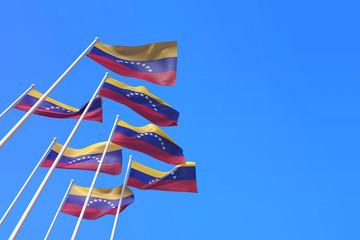 Obraz premium Venezuela flags waving in the wind against a blue sky. 3D Rendering