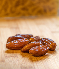 dates on wooden counter top in front of pasta