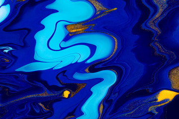 Fluid art texture. Abstract backdrop with iridescent paint effect. Liquid acrylic artwork with beautiful mixed paints. Can be used for interior poster. Blue, golden and white overflowing colors