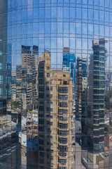 Fototapeta na wymiar Reflection of buildings in the glass of a high-rise building