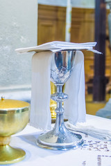 chalice with wine, blood of christ, and pyx with bread, body of christ, ready for the communion of the faithful