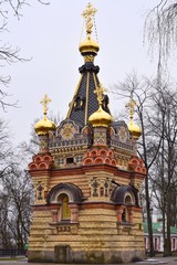 Fototapeta na wymiar Gomel, Belarus - March 2020. Beautiful chapel-tomb of the Paskevich family in park near Rumyantsev-Paskevich Palace, Gomel. Religion building with smalt mosaic and carved stone on the facade. 