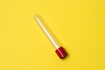 One blood collection tube on a yellow background