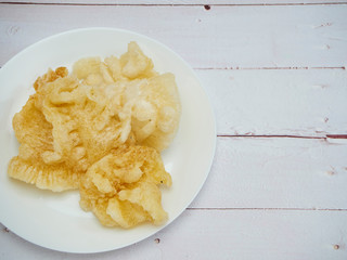 Dried maw fish on wooden table.