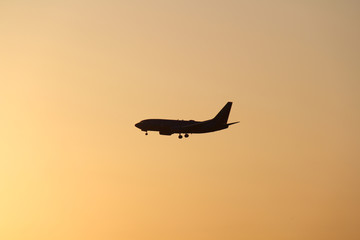 silhouette of airplane in sunset 