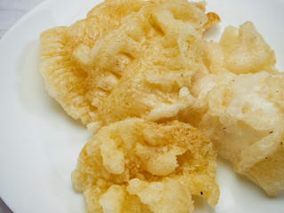Dried maw fish on wooden table.