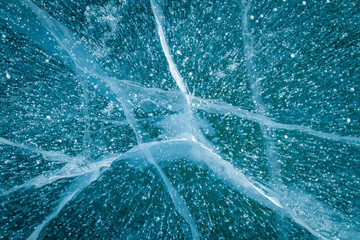 Texture of transparent ice with cracks on lake Baikal