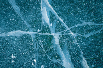 Texture of transparent ice with cracks on lake Baikal