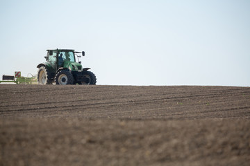 Fototapeta premium Agricultural truck working on the new crop of the spring season.