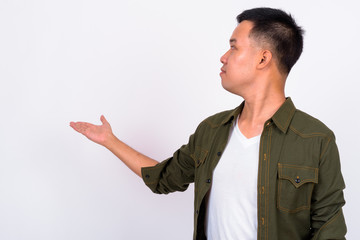 Portrait of young Asian man showing to the back