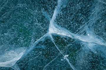 Texture of transparent ice with cracks on lake Baikal