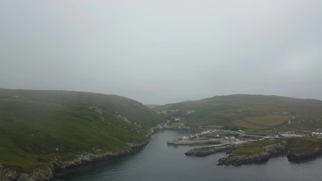 Aerial of misty island harbour