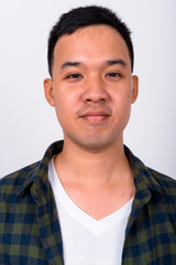 Face of young Asian hipster man looking at camera