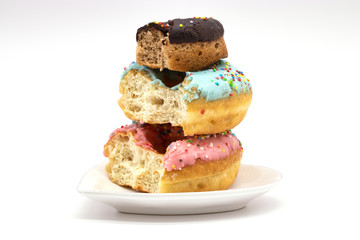 isolated delicious donuts on a white background. donut with bite. donut on heart shaped plate.