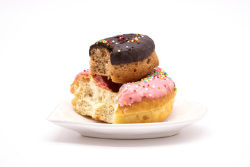 isolated delicious donuts on a white background. donut with bite. donut on heart shaped plate.