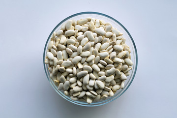 white beans in a bowl isolated on white background top view. Healthy lifestyle.
