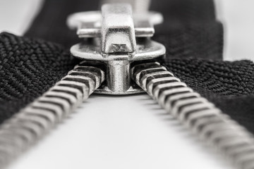 isolated black zipper with metal lock on white background © savva_25