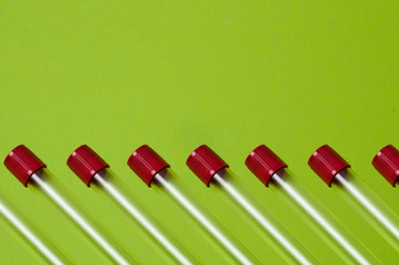 Pattern, blood collection tubes on a green background