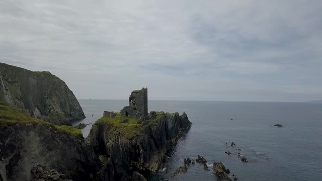 Aerial Irish castle ruins coastal flyby