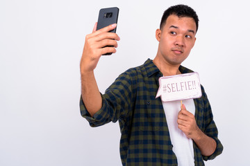 Portrait of young Asian man taking selfie with paper sign