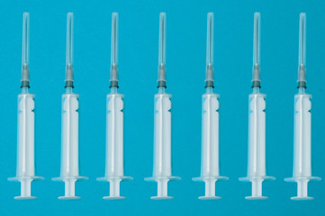 Pattern, medical white syringes against blue background