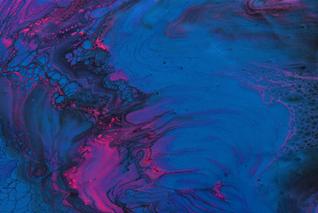 art photography of abstract marbleized effect background. Black, blue, pink and purple creative colors. Beautiful paint