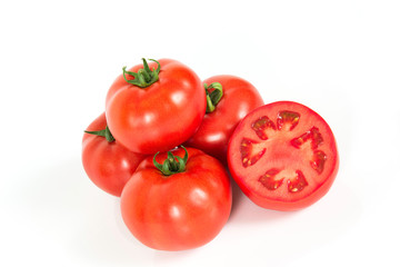 Red fresh tomatoes with sliced one on a white background