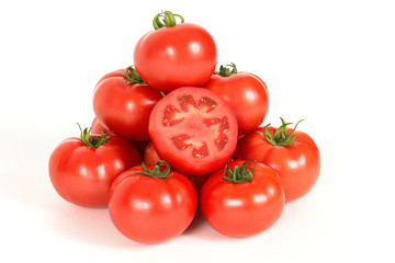 Group of red fresh tomatoes with sliced one on a white background