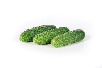 Group of fresh green pickling cucumbers on white background