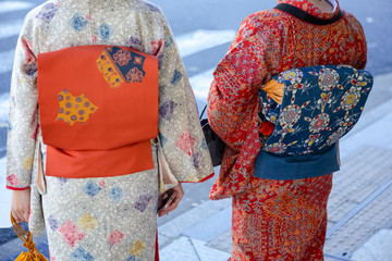 Kyoto Traveling. Geishas in Traditional Japanese Kimono and Backpacks Posing in Kyoto City,  Japan.
