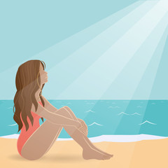 Side view of a beautiful girl sitting on the beach. It is illuminated by the Sun.