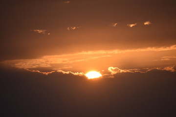 Sunrise in the summer with golden clouds.