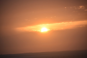 Sunrise in the summer with golden clouds.