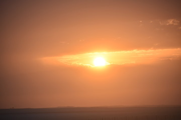Fototapeta na wymiar Sunrise in the summer with golden clouds.