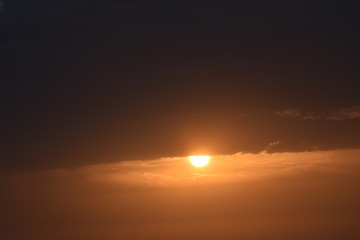 Sunrise in the summer with golden clouds.