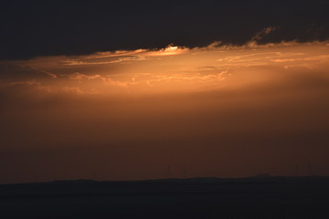 Sunrise in the summer with golden clouds.
