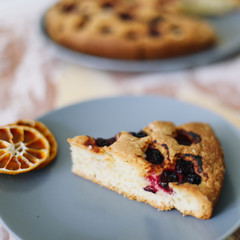 Piece of pie on plate with cup of tea on white table. Breakfast with tea and cake. Food photography. Table top photo. Tea time