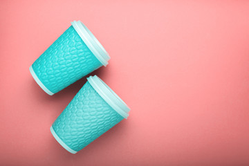blue cardboard coffee glasses on bright background