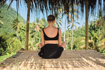 Back view of beautiful girl relaxing with amazing view on island