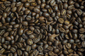 Roasted Coffee beans on grunge wooden can be used as a background