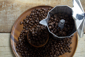 Roasted Coffee beans on grunge wooden can be used as a background