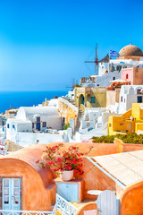 Greece Traveling. View of Greek Traditional Colorful Houses and Windmills of Oia or Ia at Santorini...