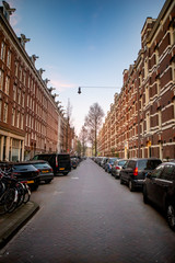 Typical Amsterdam street, white and red brick, 4 stories.