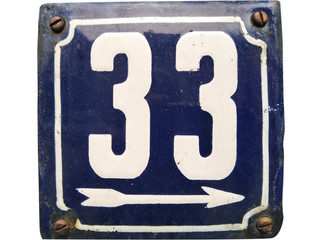 Weathered grunge square metal enameled plate of number of street address with number 33 closeup
