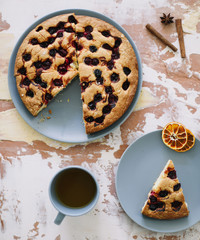 Piece of pie on plate with cup of tea on white table. Breakfast with tea and cake. Food photography. Table top photo. Tea time