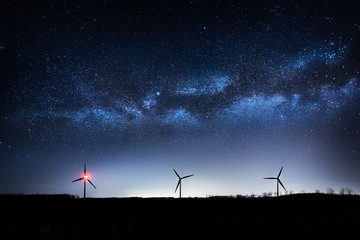 Wind turbines in the night - Powered by Adobe