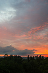 Landscape with dramatic light - beautiful golden sunset with saturated sky and clouds.