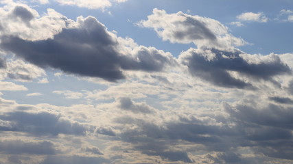 Fluffy clouds of the spring sky. Cold sky with clouds.