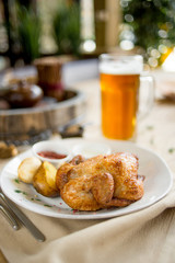 Grilled chick with potato and sauce on cafe restaurant table on terrace bokeh